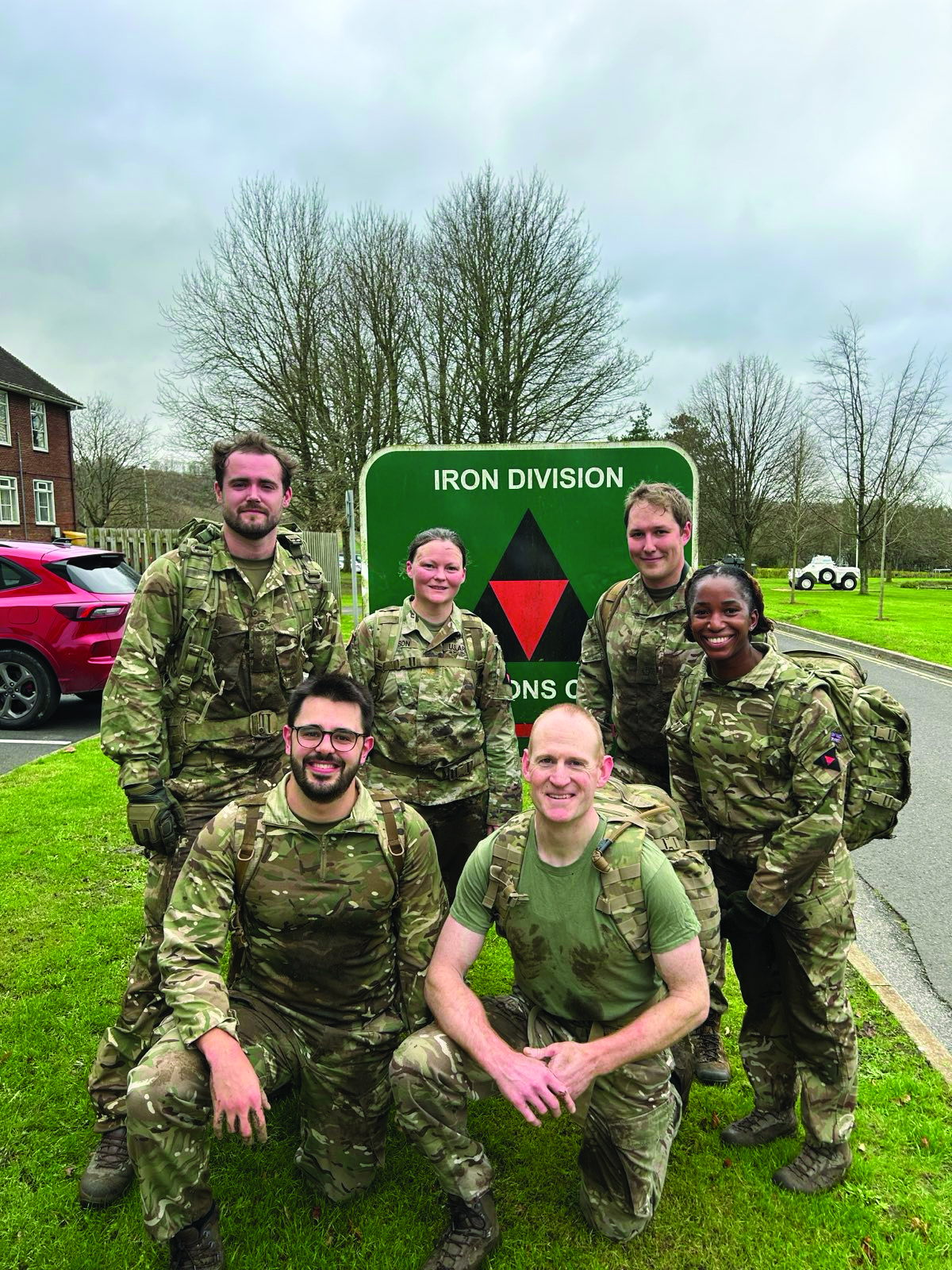 MAJ Amanda Dixson (standing, second-from-left),
      legal exchange officer with 3rd (UK) Division, stands
      with members of the 3rd (UK) Division legal team,
      including Lieutenant Colonel (UK) Andy Farquhar
      (kneeling, right), former deputy director of the Legal
      Center, The Judge Advocate General’s Legal Center
      and School, in Charlottesville, VA. (Photo courtesy
      of author) 